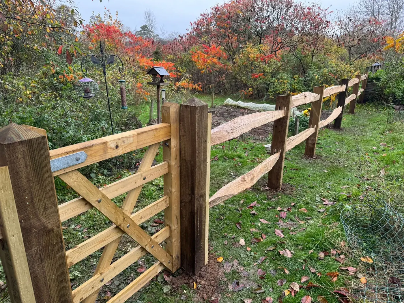 New timber five bar gate hung beside cleft chestnut post and rail fencing