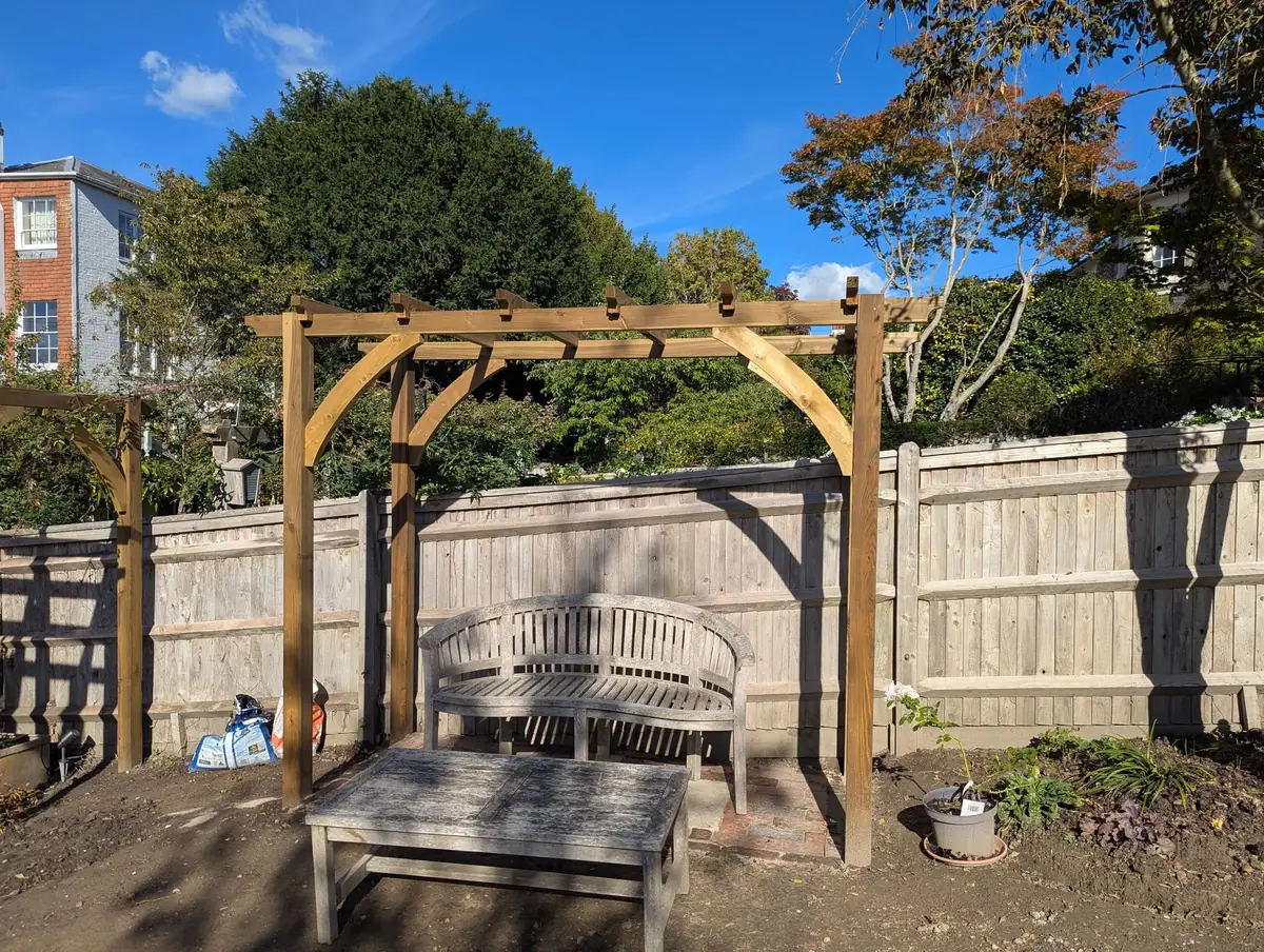 Timber pergola over a garden seating area in Tunbridge Wells, built by Tyrrells